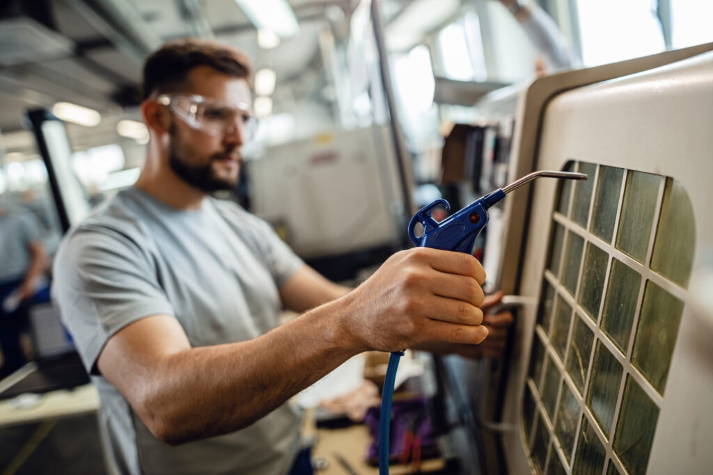 close up of worker at industrial production line facility.